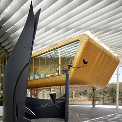 A tent with a chair and a table in front of it.